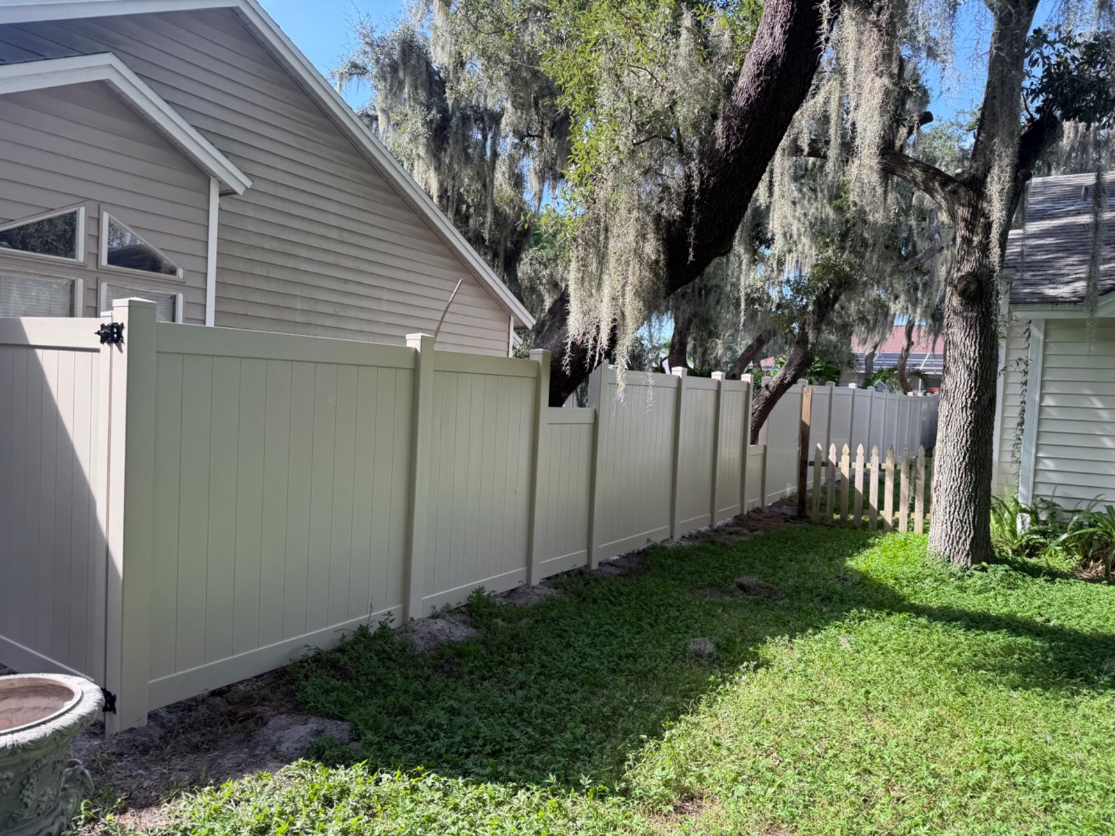 Vinyl privacy fence beside a home