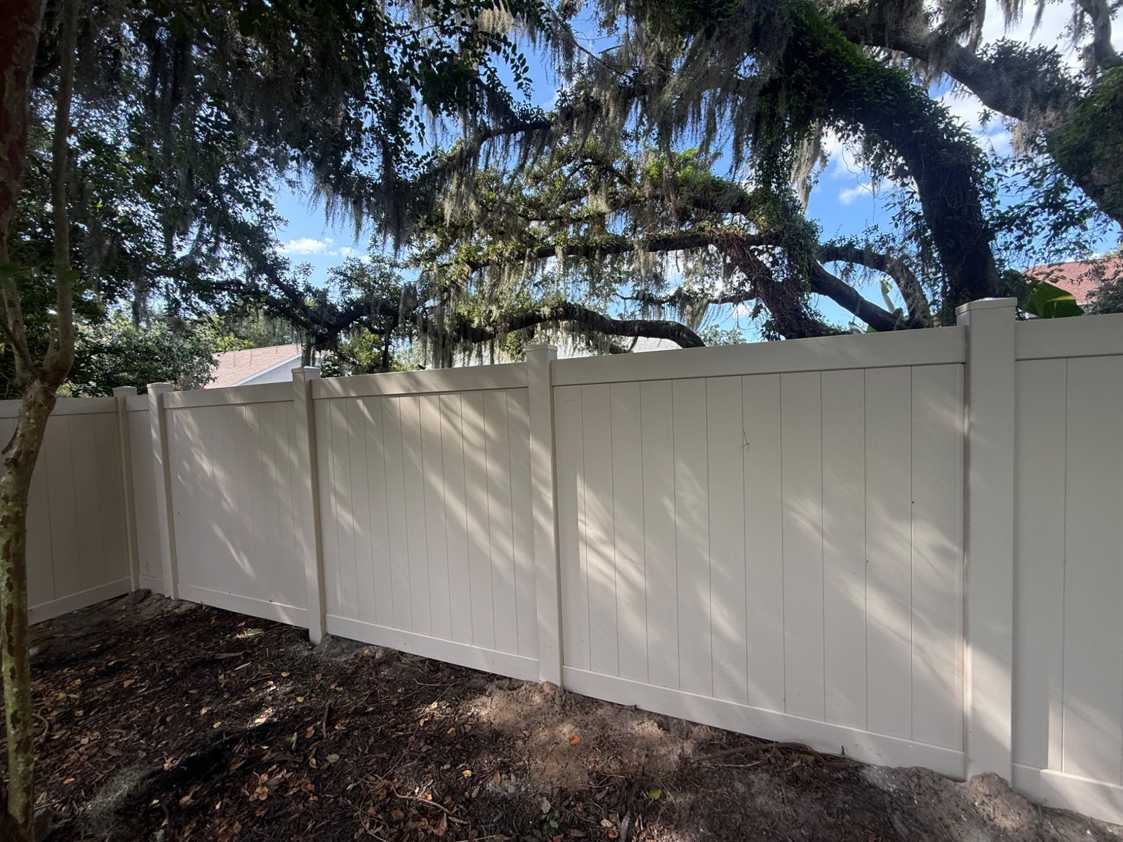 Close view of white vinyl panels and posts