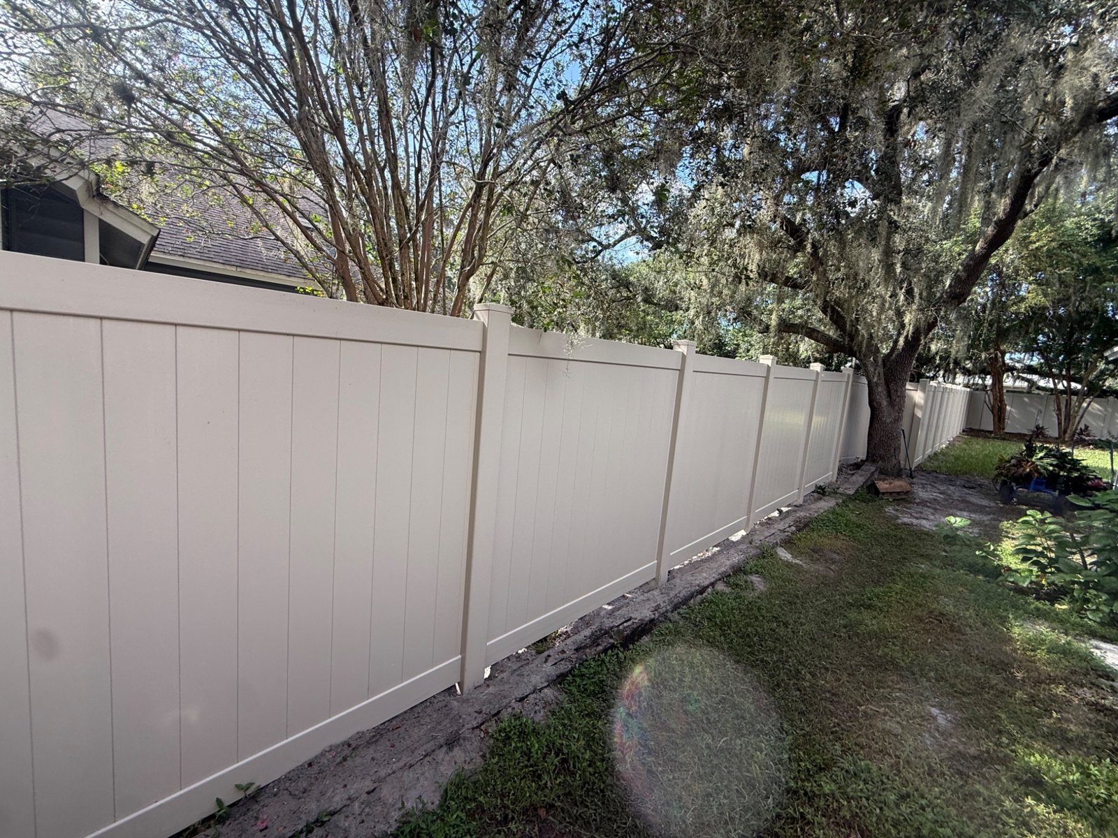 Long run of white vinyl privacy fencing