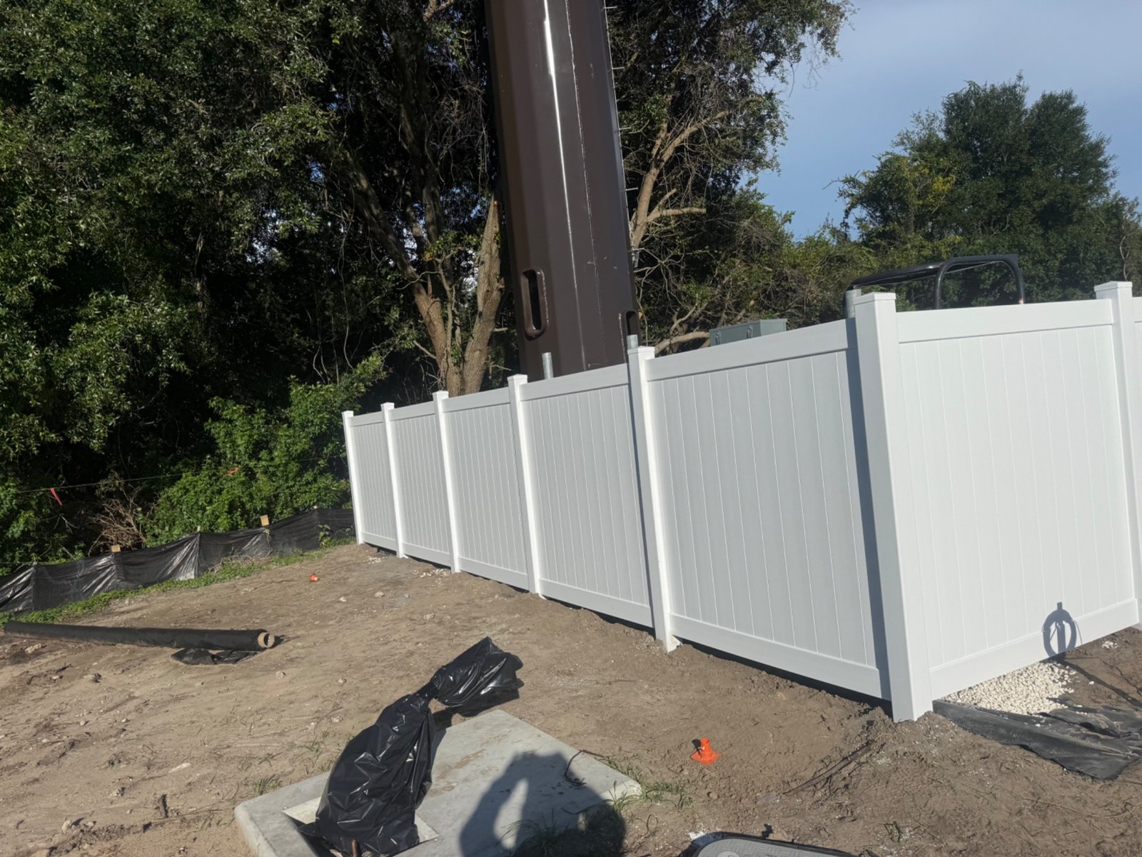 White vinyl fence at a project site