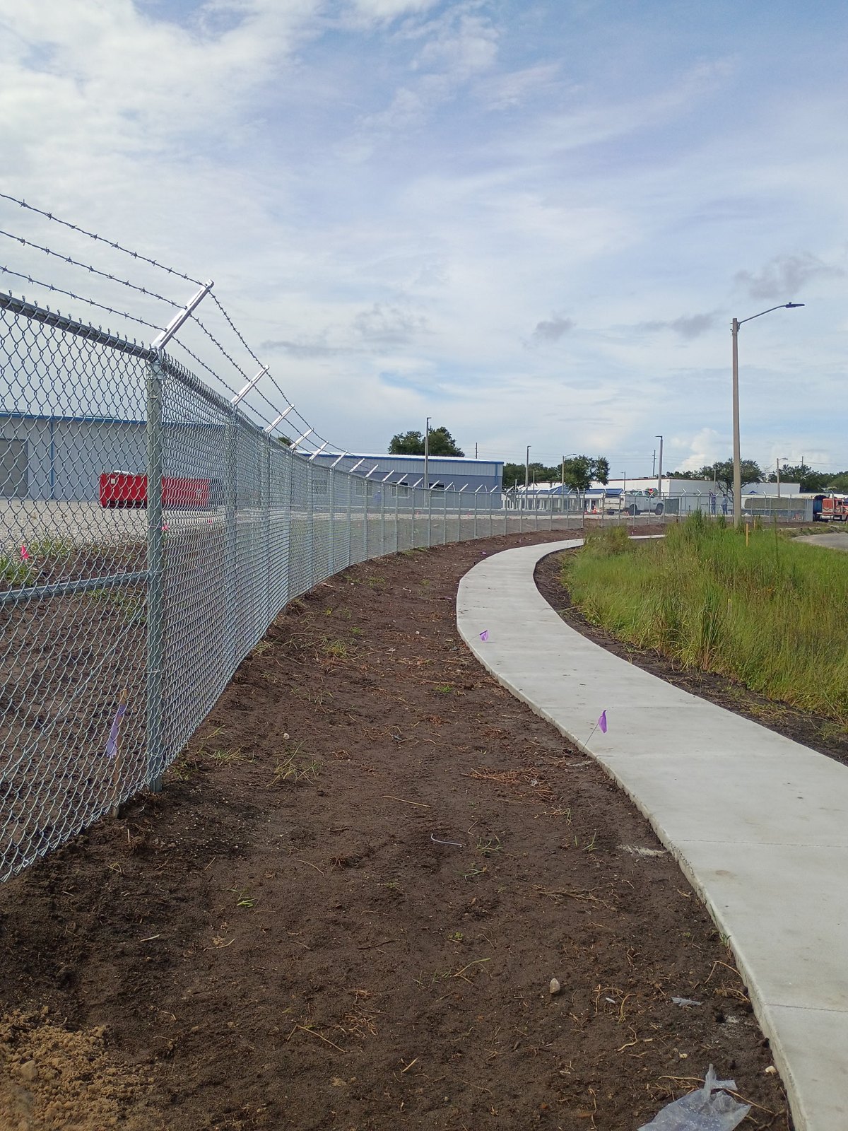 Chain link perimeter beside a curved walkway