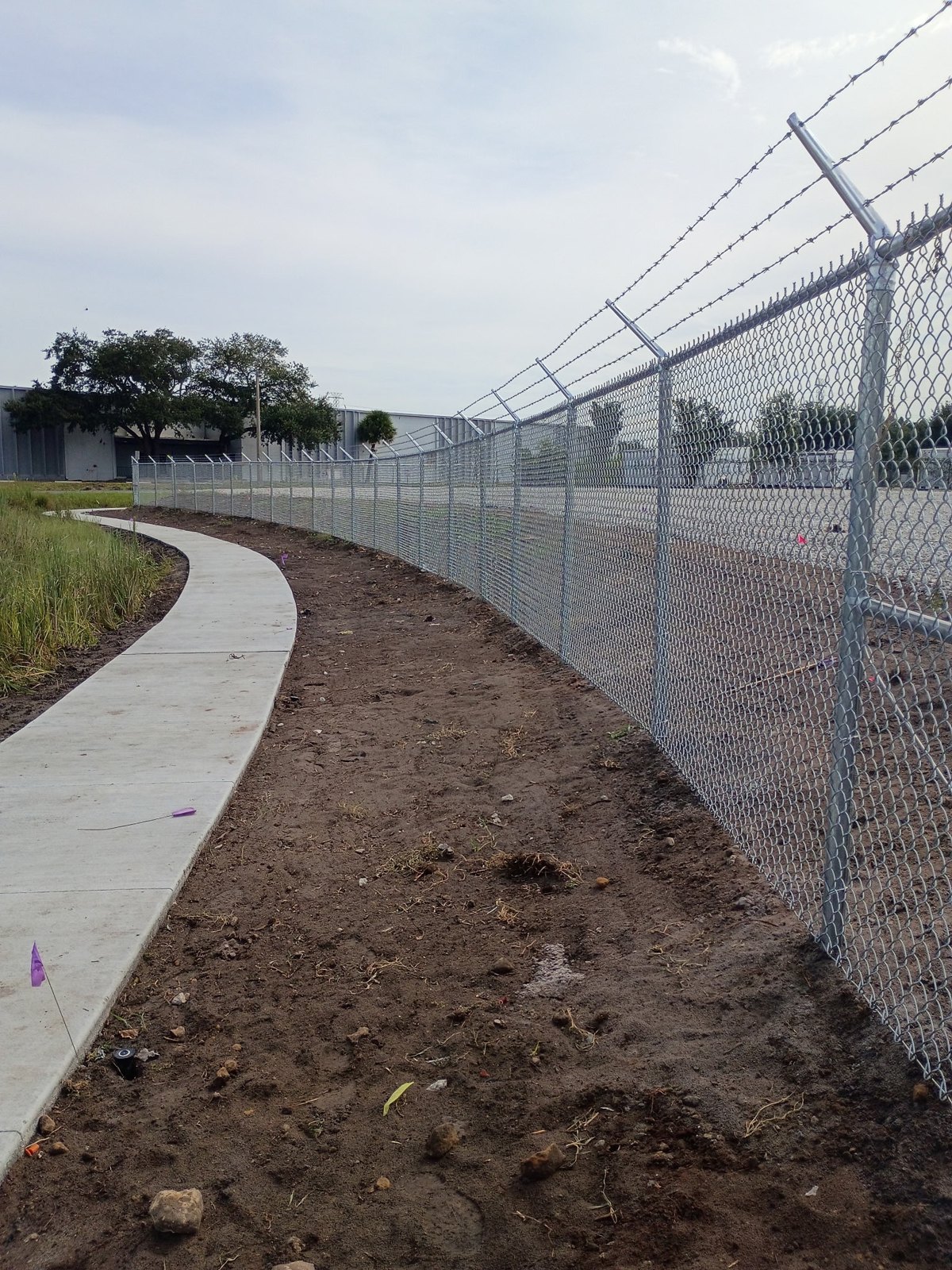 Galvanized chain link perimeter fencing with angled post extensions