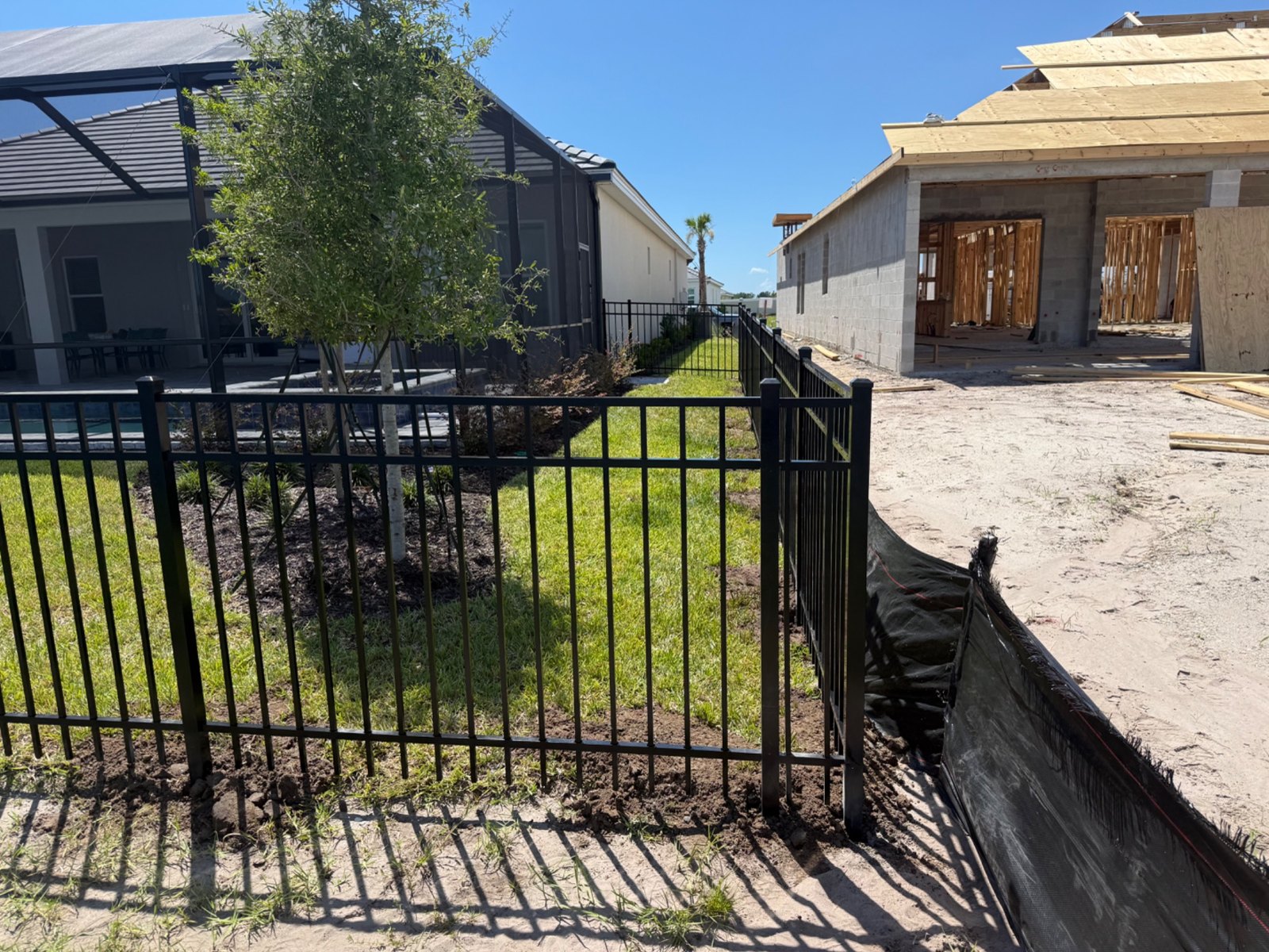 Aluminum gate and fence along a side yard