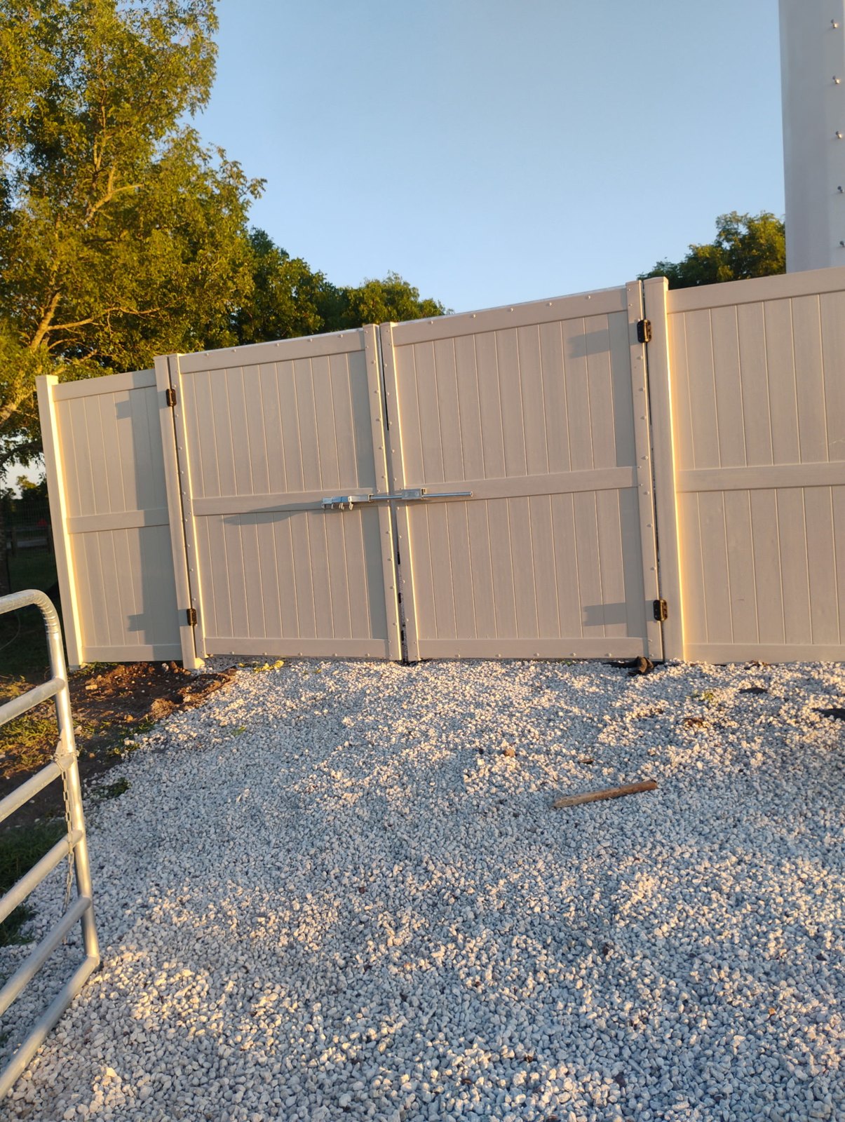 Tan vinyl privacy fencing — view 2