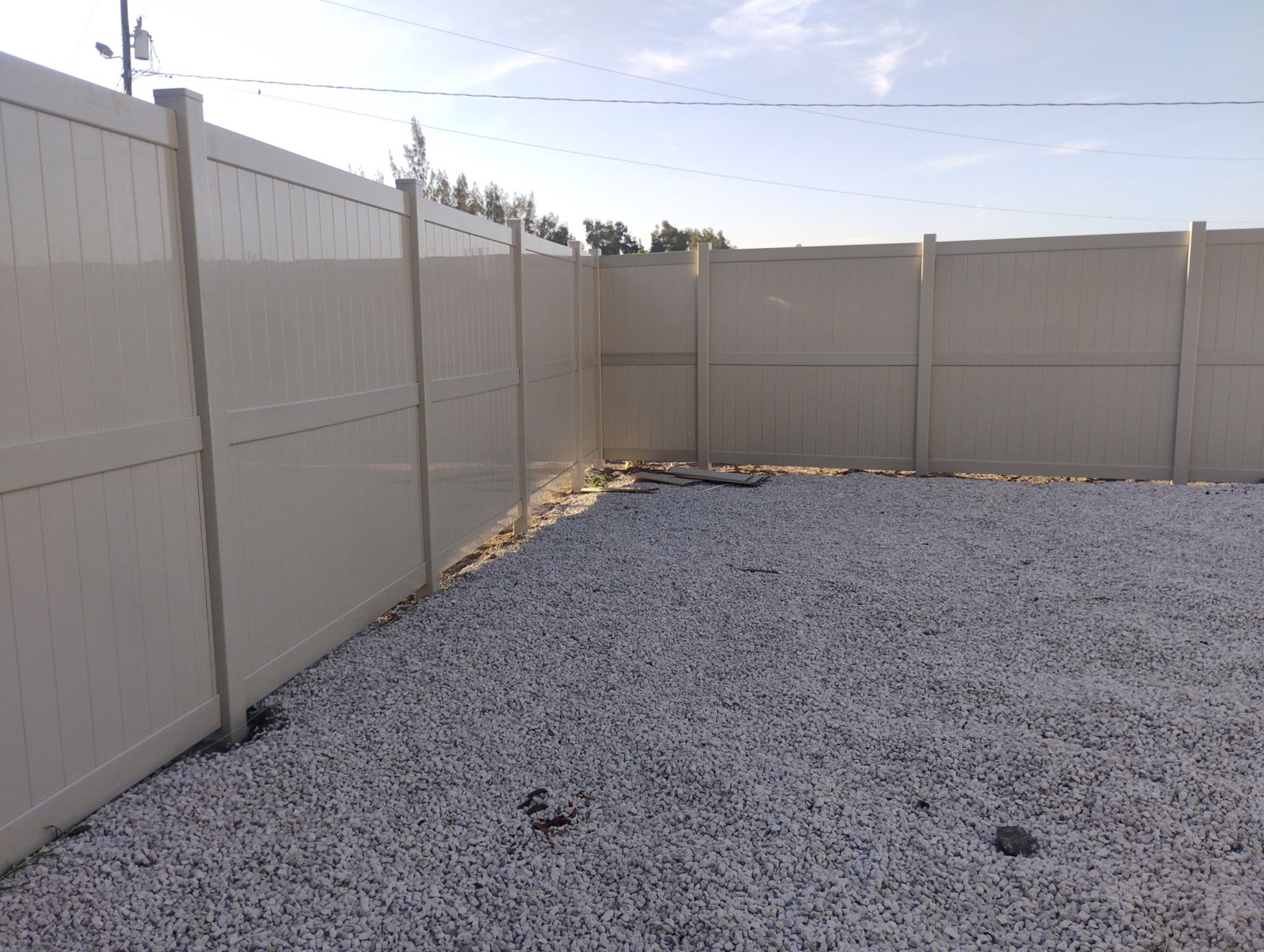 Tan vinyl privacy fencing — view 6