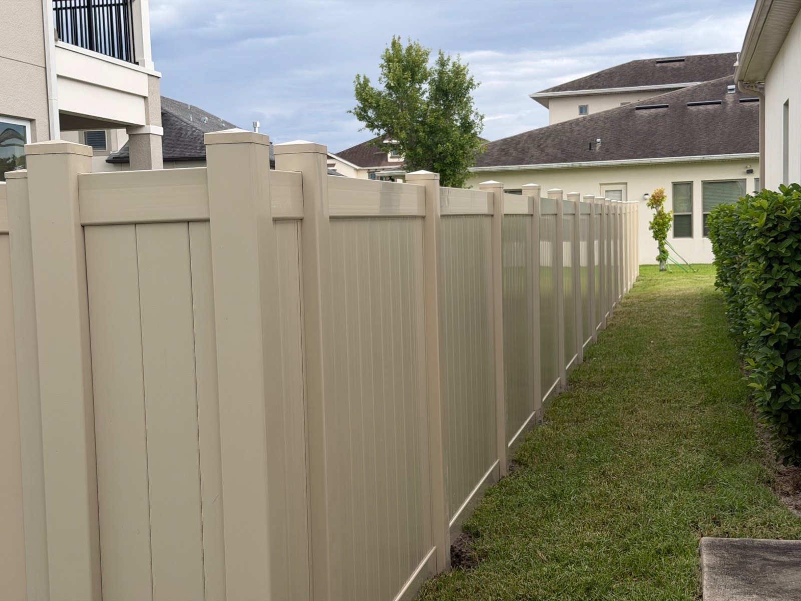 Tan vinyl privacy fencing — view 17