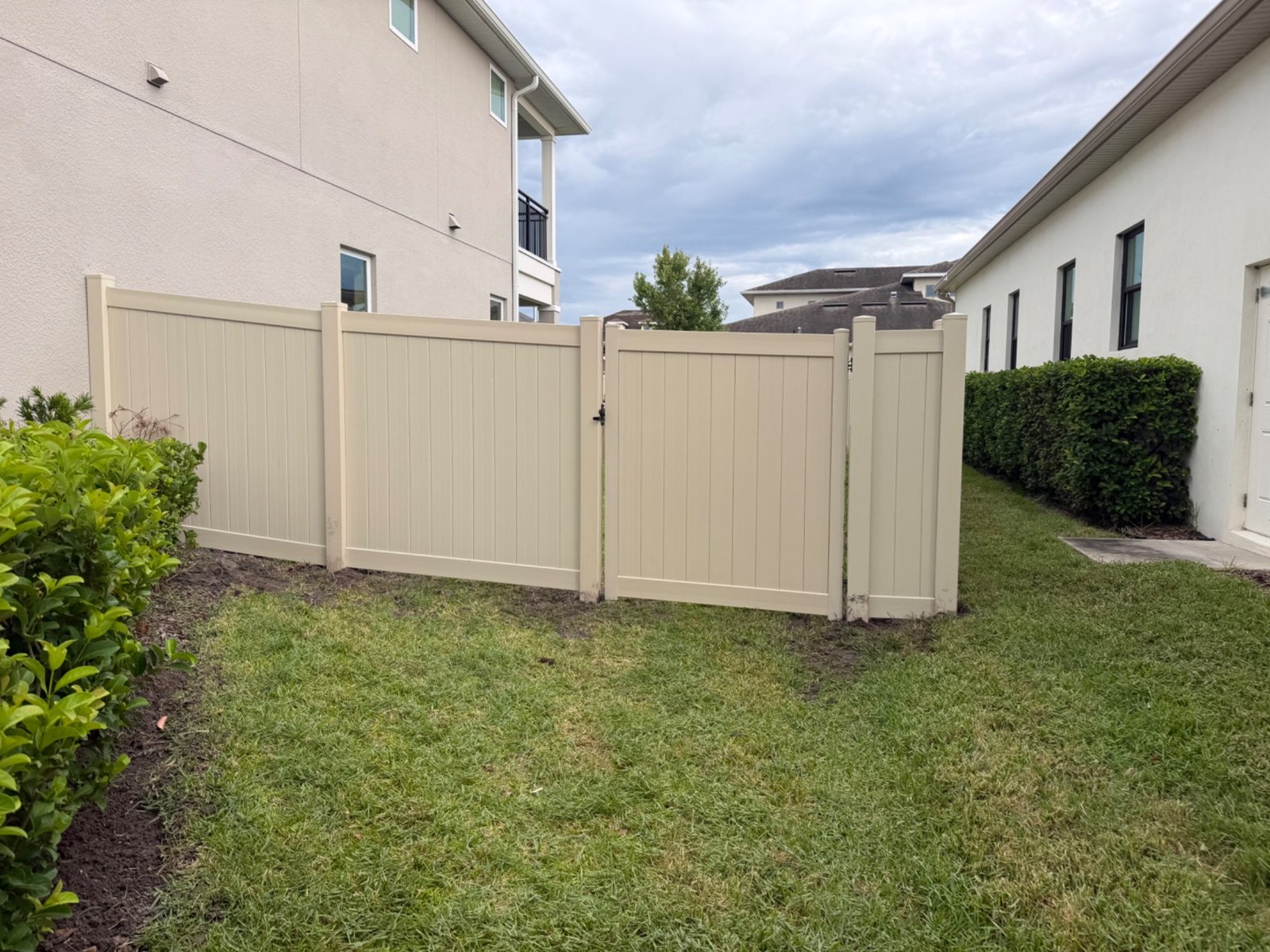 Tan vinyl privacy fencing — view 19