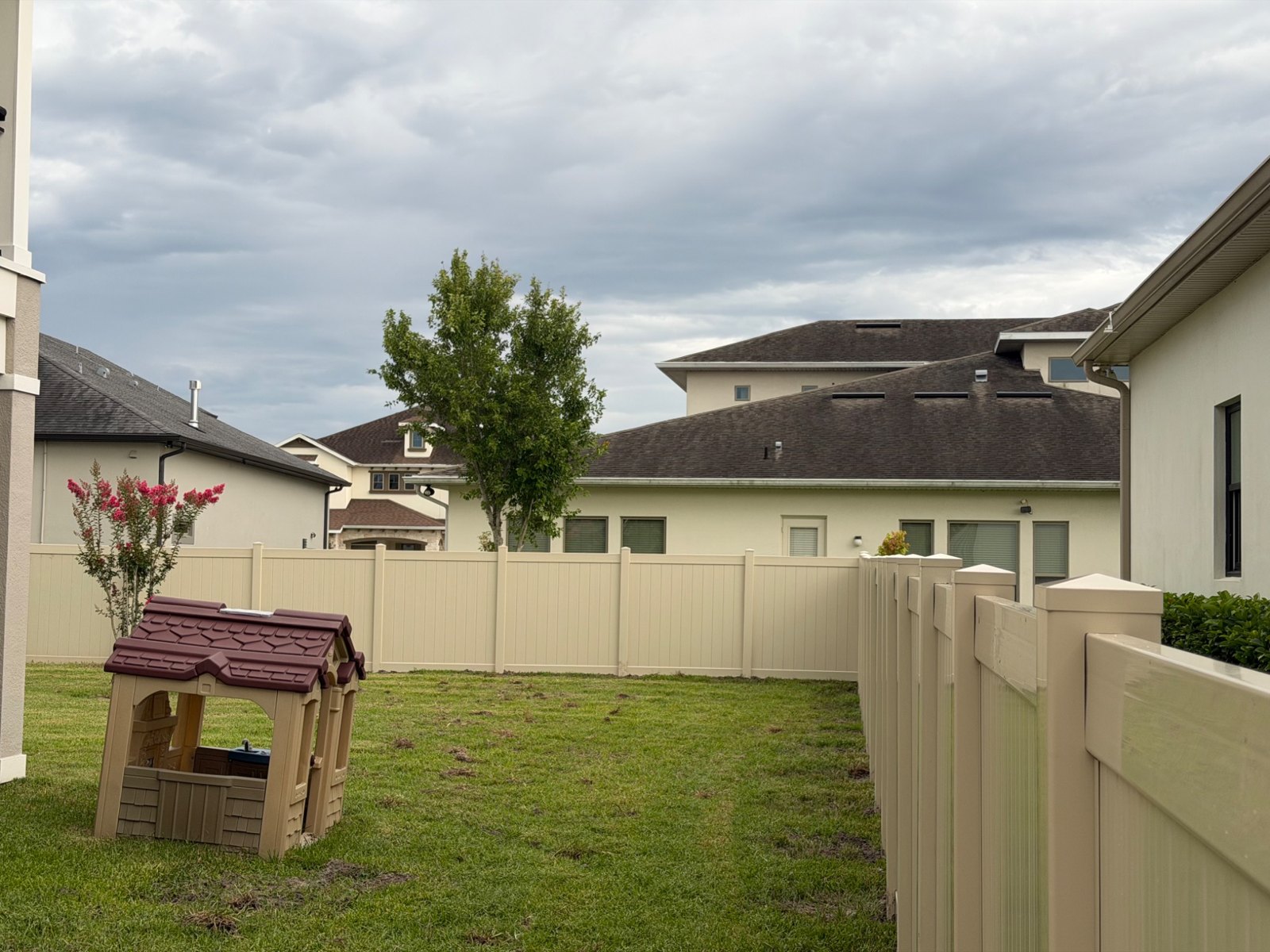 Tan vinyl privacy fencing — view 20
