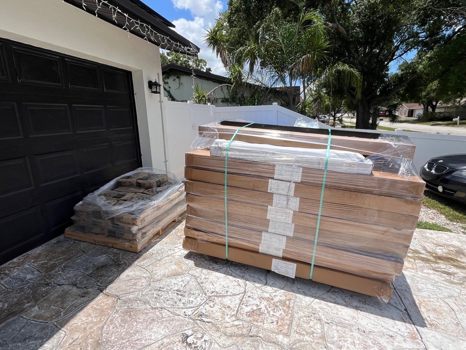 Packaged fence panels in a driveway