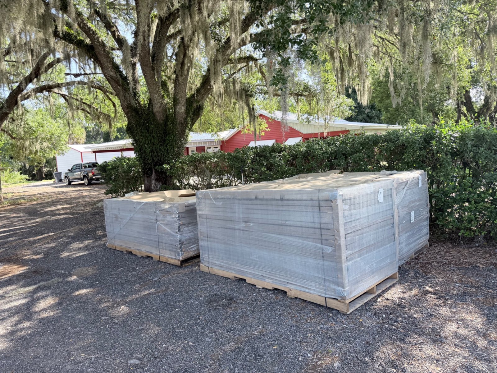 Wrapped fence panels delivered beneath trees
